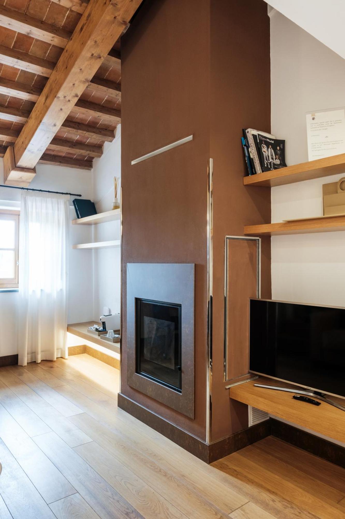 빌라 톨로메이 호텔&리조트 피렌체 외부 사진 A fireplace in a hotel room